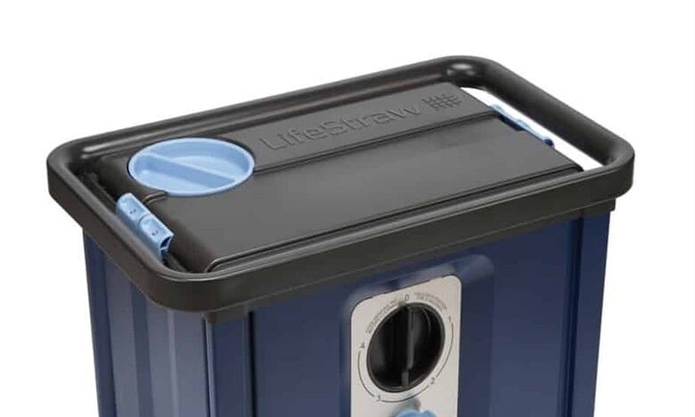 Blue and black portable waste or storage container with control knob and hose.