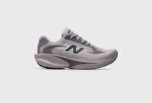 Light grey New Balance running shoe with cushioned sole and breathable mesh upper, ideal for running and athletic activities.