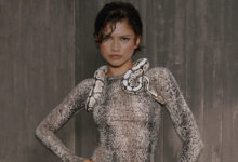 Zendaya poses confidently with a snake draped over her shoulders, showcasing her bold fashion style for the new co-created collection with On and Zendaya.
