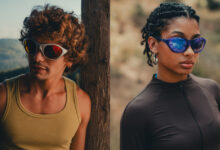Two runners wearing sunglasses outdoors, one male with curly hair and a yellow tank top, and one female with braided hair and a black athletic top, preparing for a run.