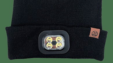 Black knit beanie with a mounted rectangular LED headlamp, designed for hands-free illumination during outdoor running.