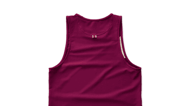Vibrant magenta running tank top designed for athletes, featuring moisture-wicking fabric and ergonomic fit for optimal performance during training and races.