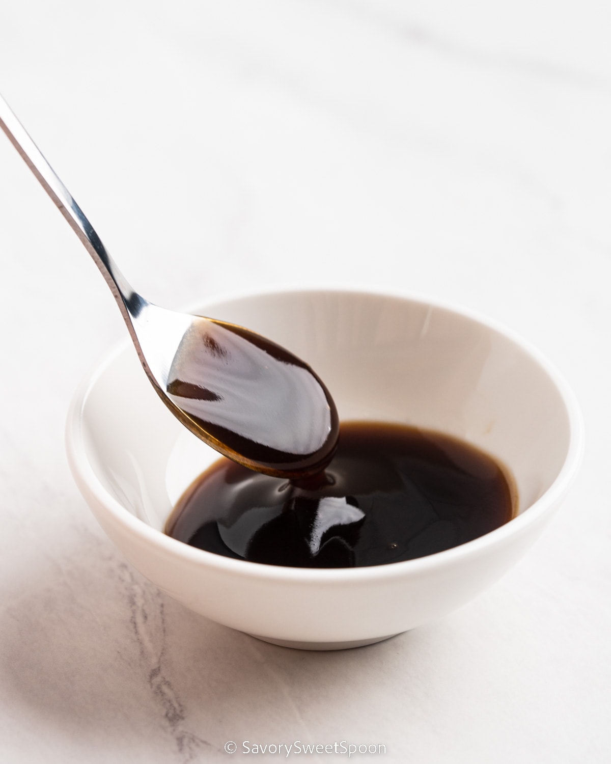 bowl and spoonful of oyster sauce.