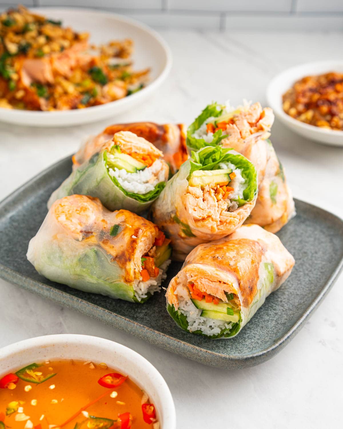 6 salmon spring rolls cut in half and stacked.