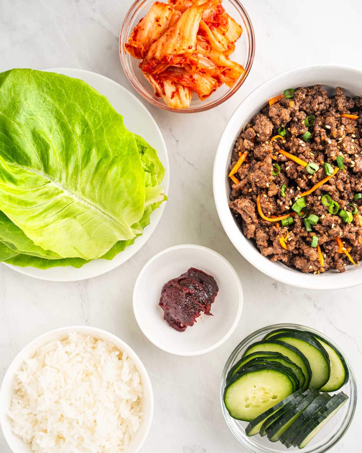 ingredients and toppings for Korean beef lettuce wraps.
