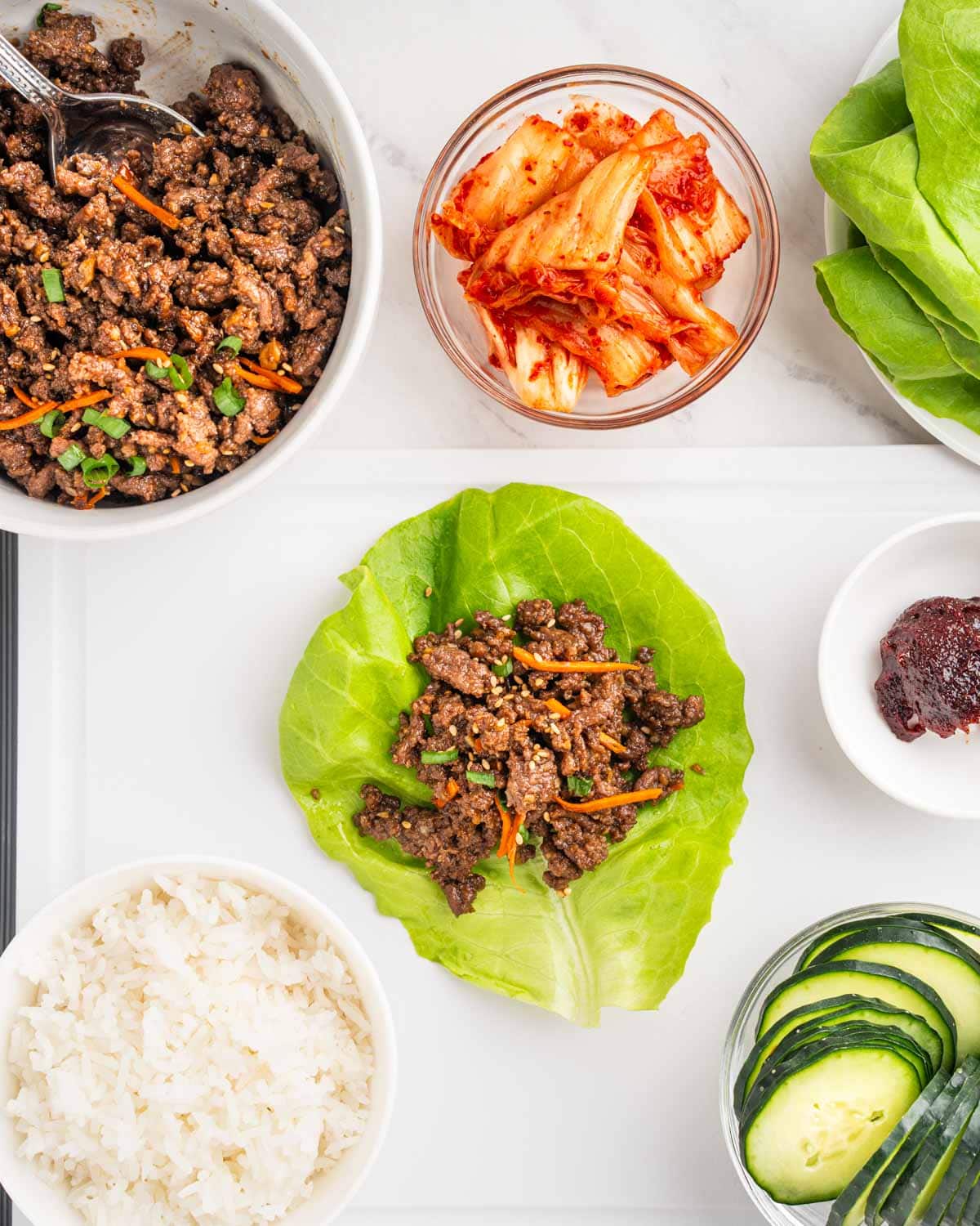 Assembling lettuce wraps with Korean beef.
