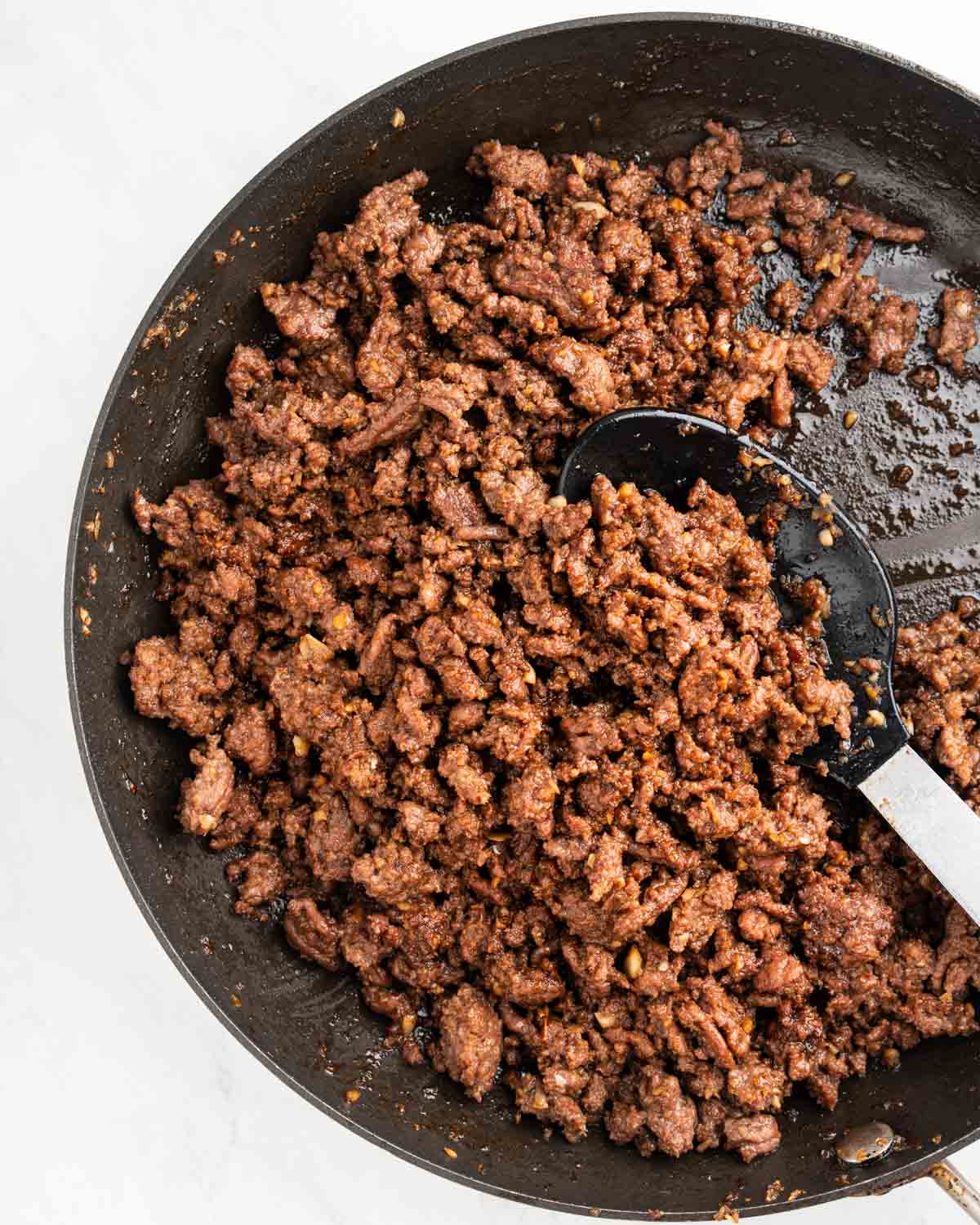 Sautéed ground beef in pan.