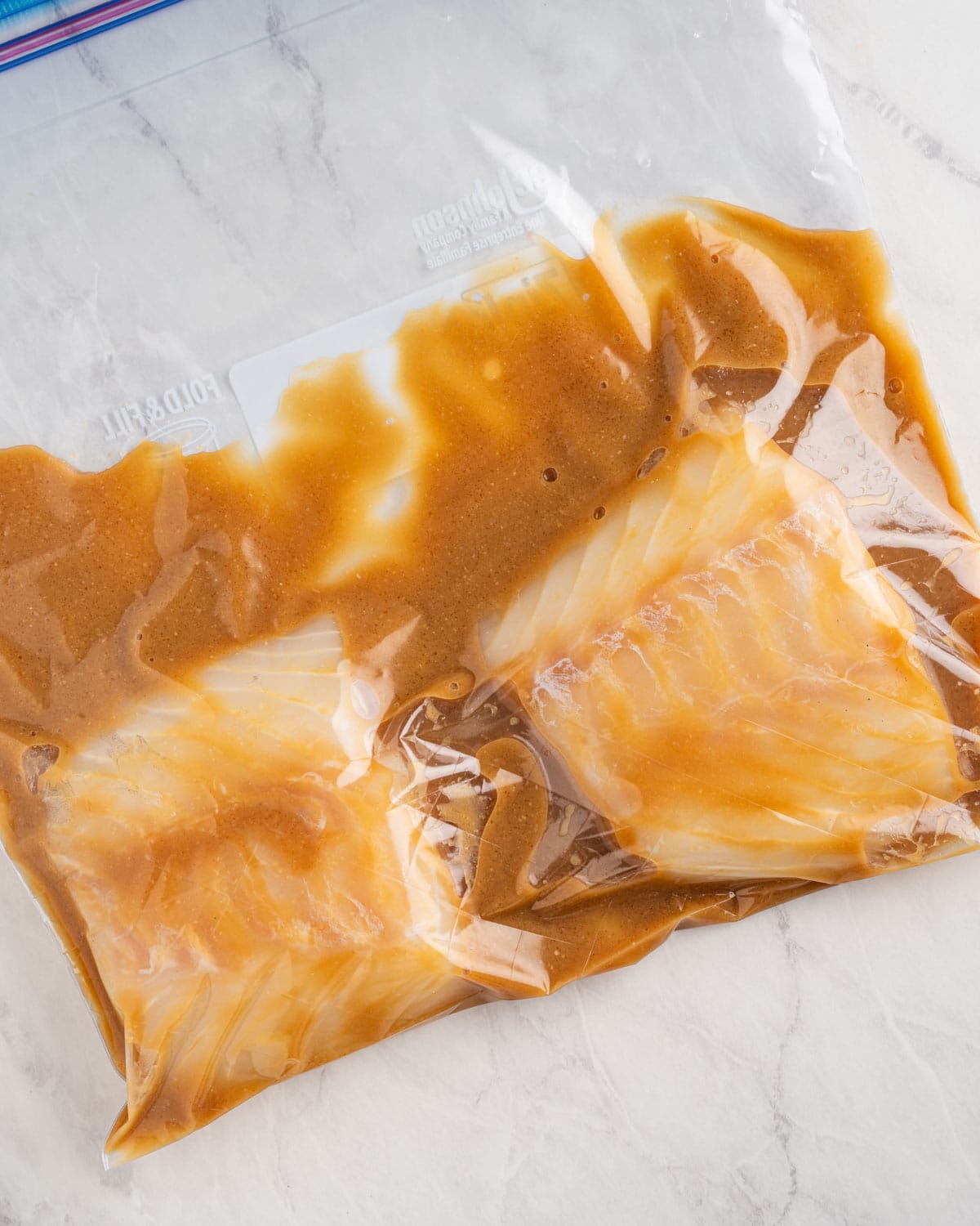 Marinating cod with miso sauce in ziplock bag.
