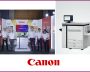 Canon team at an imagePRESS V770 launch booth beside the production printer