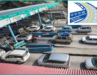Vehicles passing through an NHAI FASTag toll plaza
