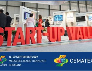 Start-Up Valley booth at ITMA 2027 with visitors and displays.