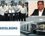 Group photo with HEIDELBERG printing press and executive portrait.