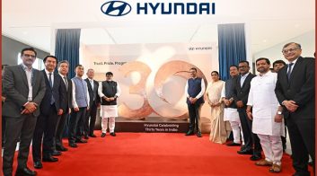 Group of people celebrating Hyundai's 30 years in India at Pune plant.