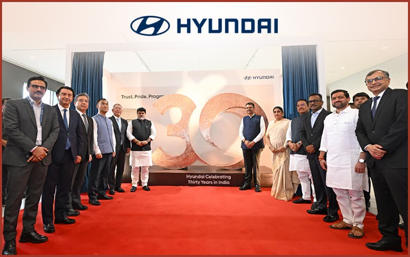 Group of people celebrating Hyundai's 30 years in India at Pune plant.