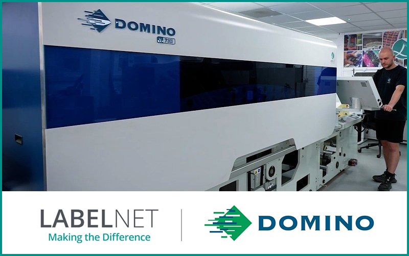 Large Domino digital printing press in a printing facility with operator.