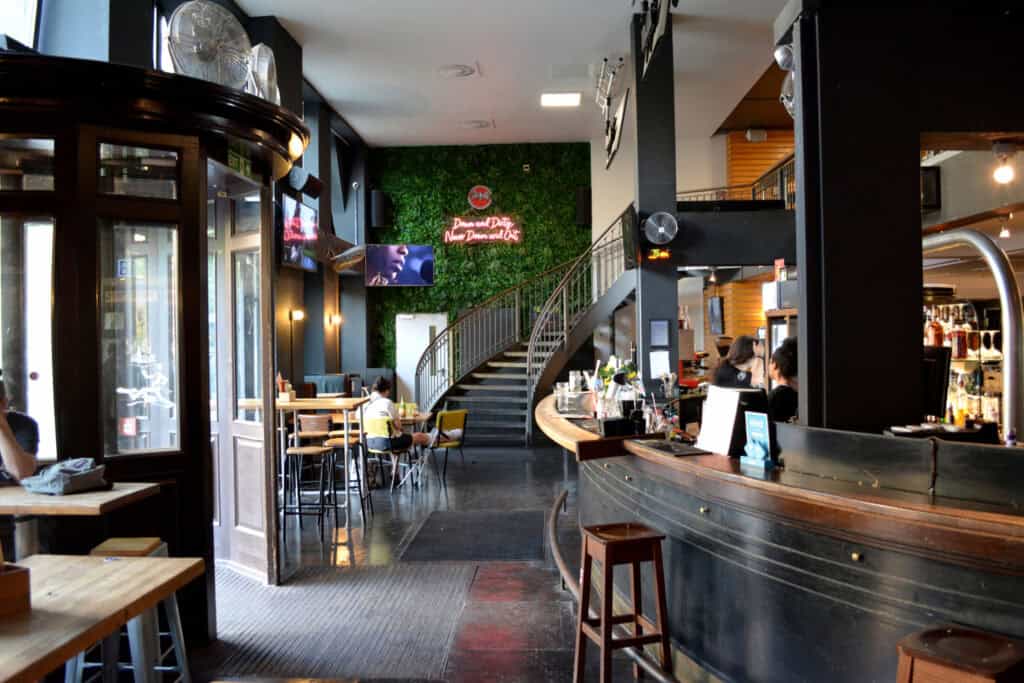 Flying Pig Downtown hostel interior with modern decor and bar area.
