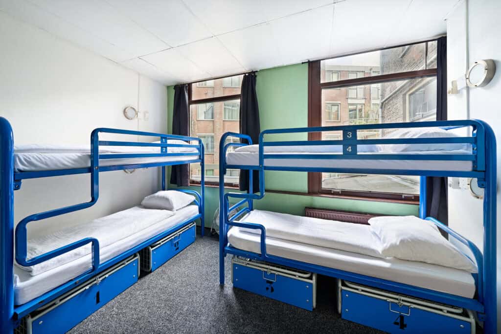 Bunk beds in a bright, modern hostel room at Flying Pig Downtown, ideal for budget travellers seekin.