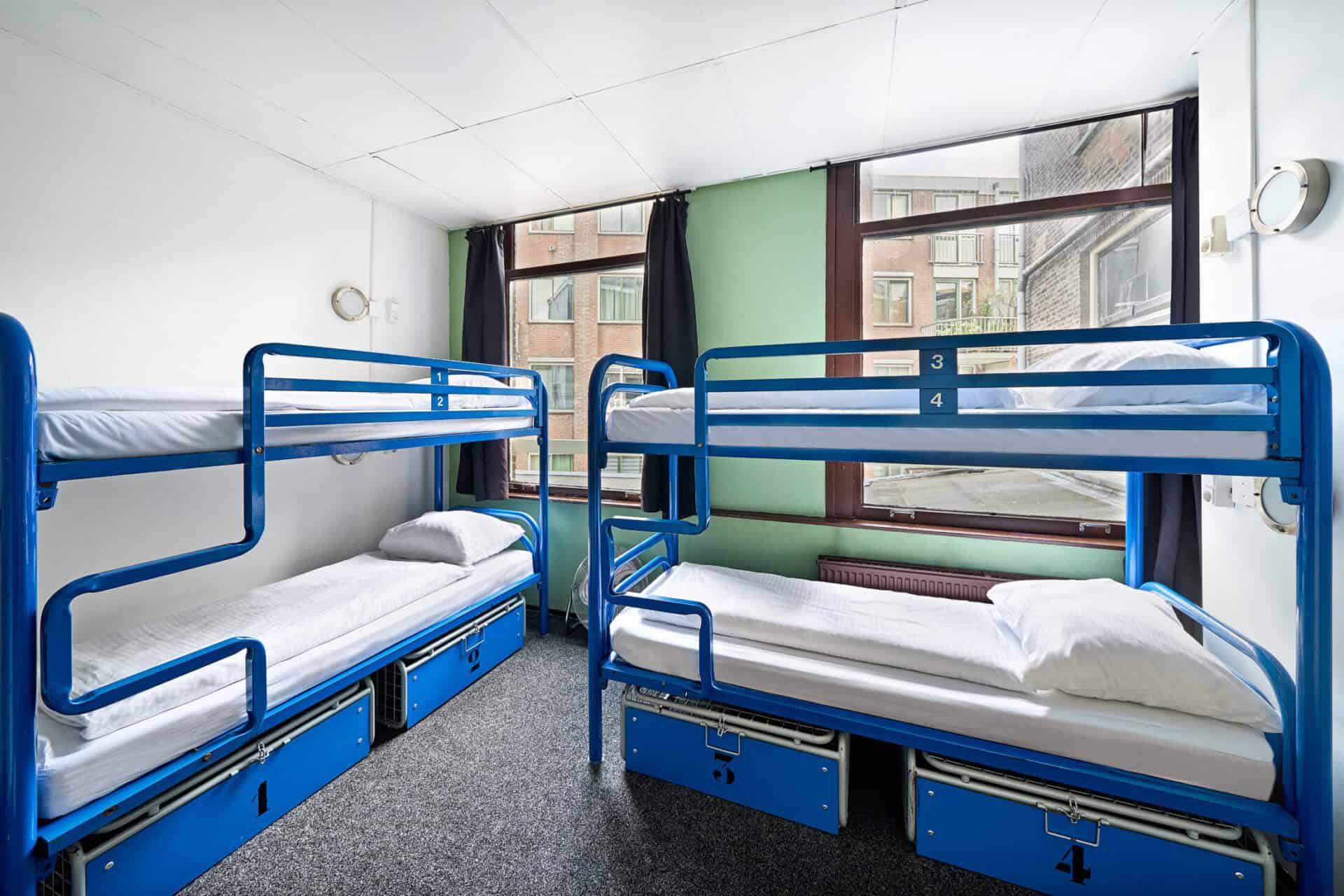 Bunk beds in a bright, modern hostel room at Flying Pig Downtown, ideal for budget travellers seekin.