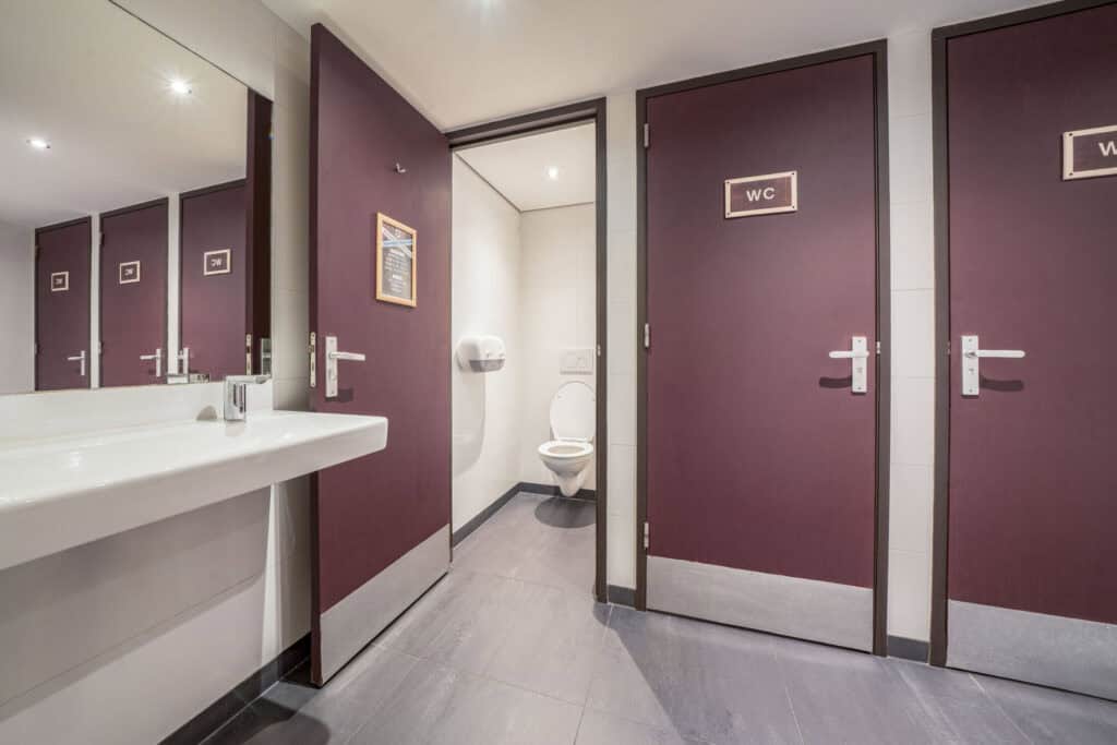 Modern hostel restroom with clean facilities and accessible WC in downtown location.