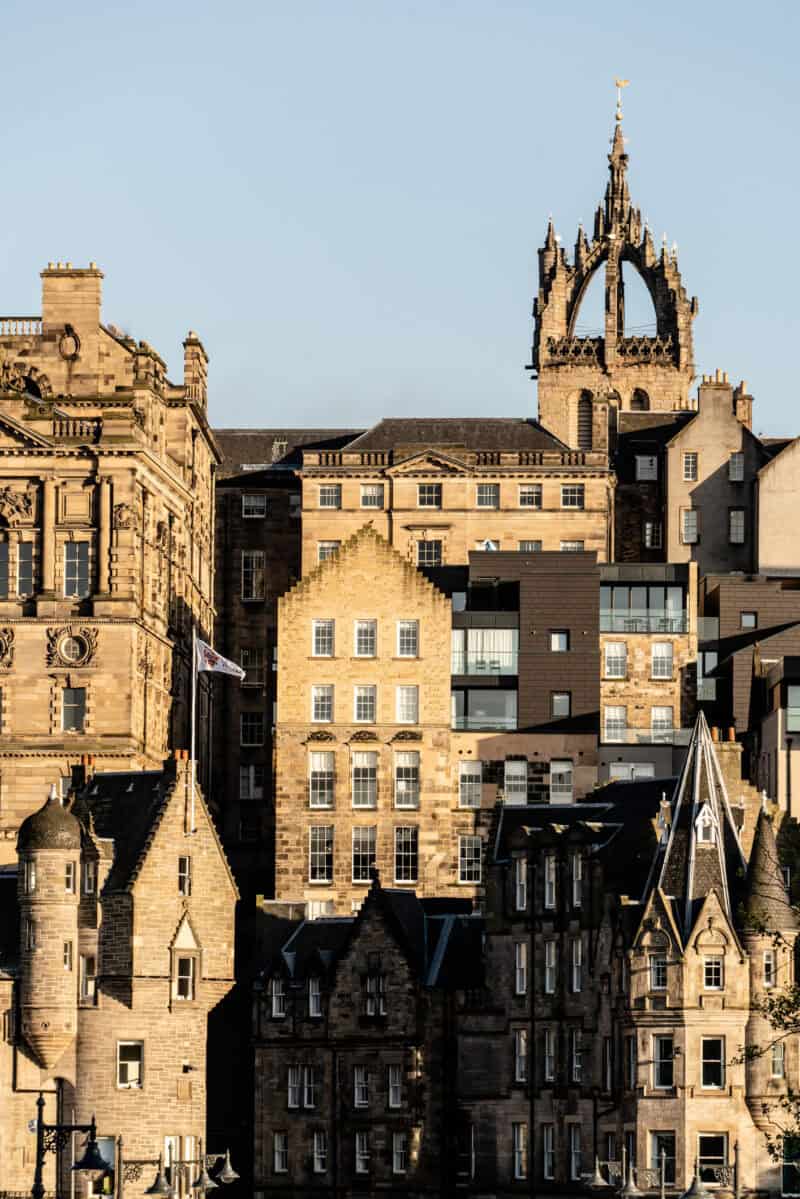 Cityscape with historic stone buildings and a gothic church spire. at St Christopher's Edinburgh Old Town hostel
