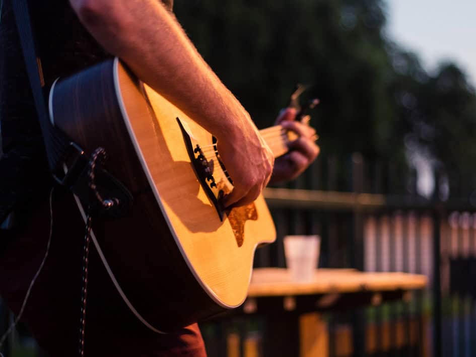 St Christopher's Inn London Bridge - The Inn, person playing guitar in outdoor social space.