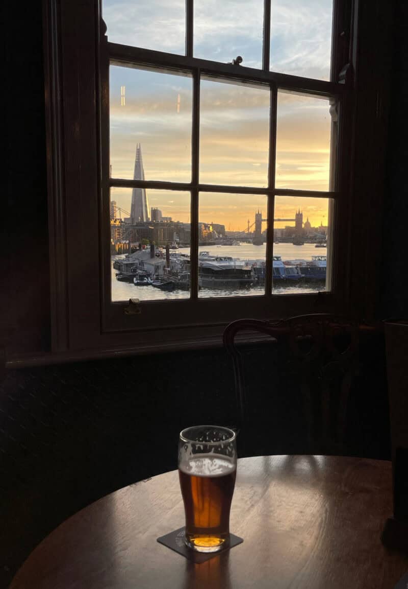 View of London skyline from St Christopher's London Bridge hostel with a pint on the table.