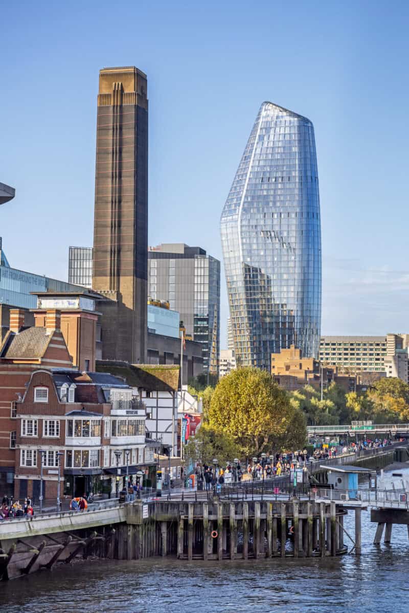 View of London Bridge Village Hostel with city skyscrapers and river in London.