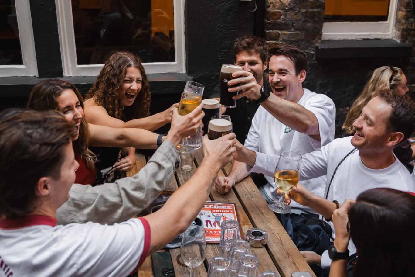 Group of friends enjoying drinks and celebrating at St Christopher's pub.