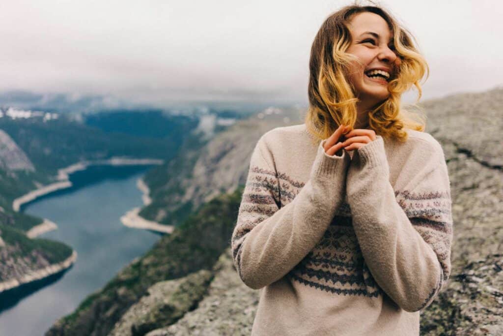 Happy woman enjoying scenic mountain view near Berlin Mitte hostel in Germany.