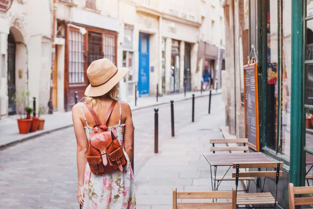 Woman walking in Berlin Mitte district, exploring local streets and cafes.
