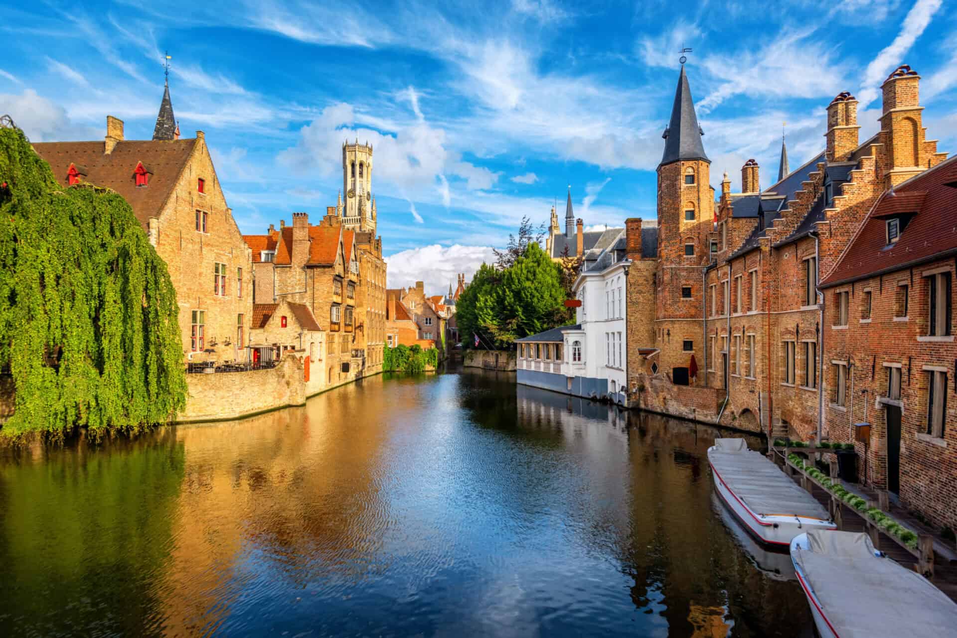 A scenic view of a city canal with historic buildings and boats in a European city.