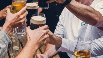 Friends raising glasses outside St Christopher's Pub, a historic pub in London Bridge on Borough High Street