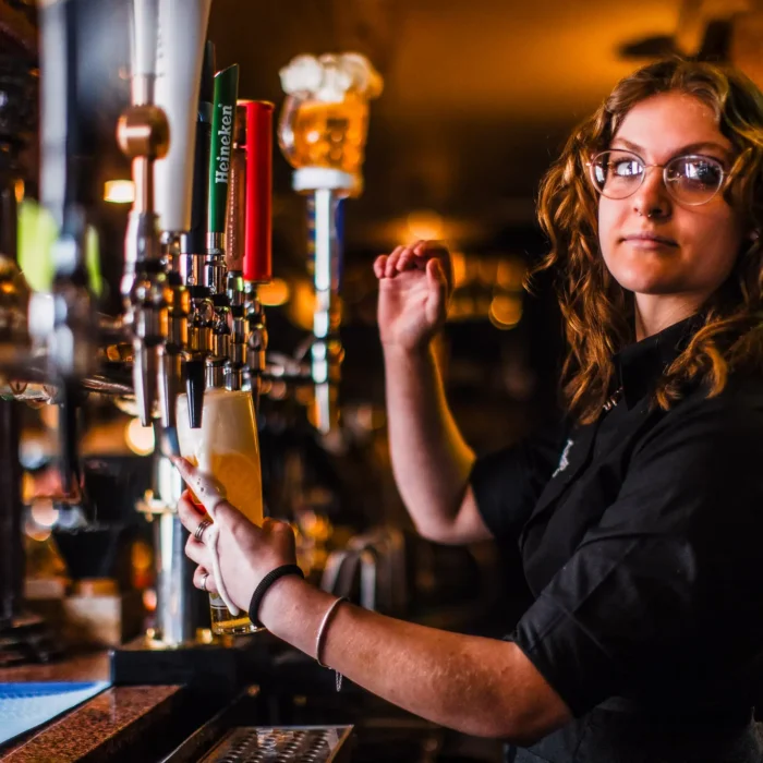 Bar staff pouring a pint at The Hercules Pillars, a traditional pub near Holborn and Covent Garden