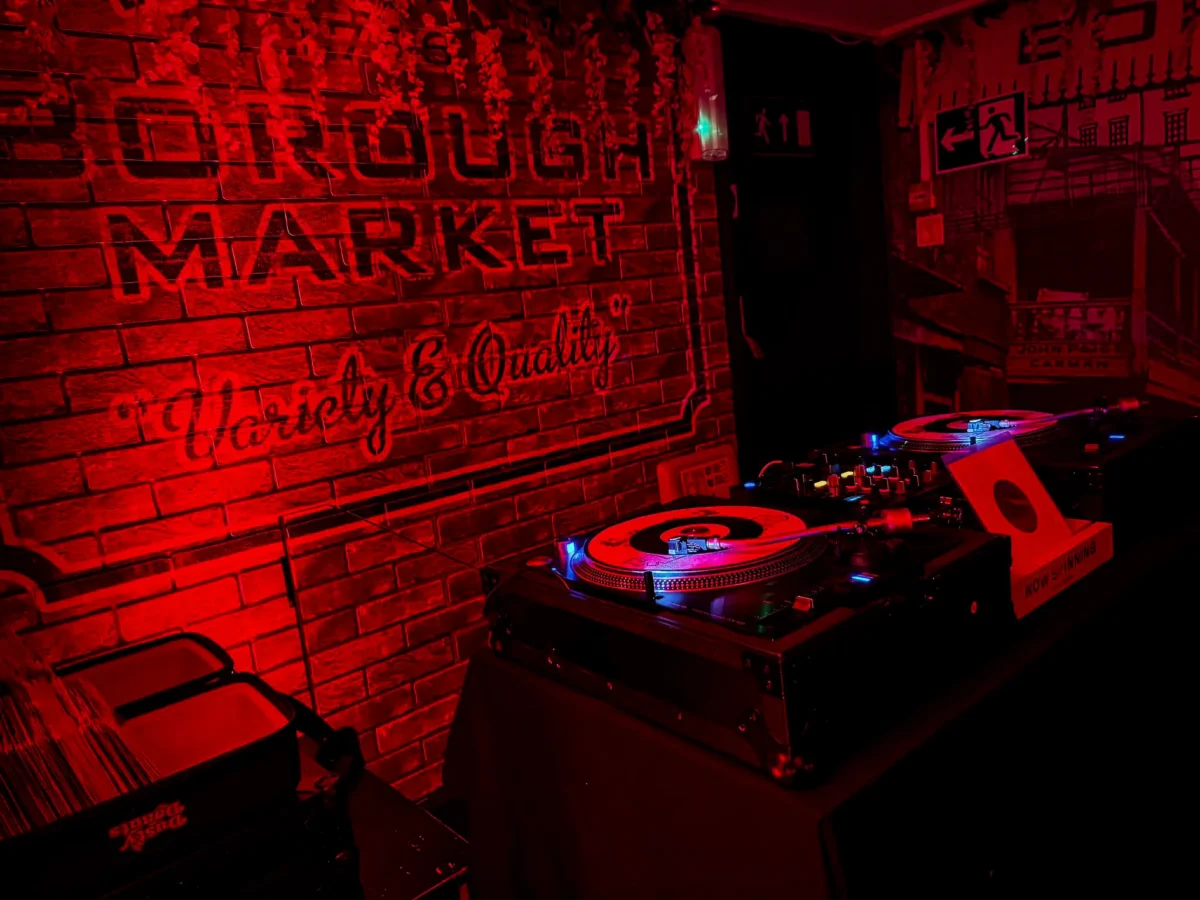 Vinyl DJ decks under red lighting in the 121 BASSment basement bar at St Christopher's Pub, Borough High Street, London Bridge
