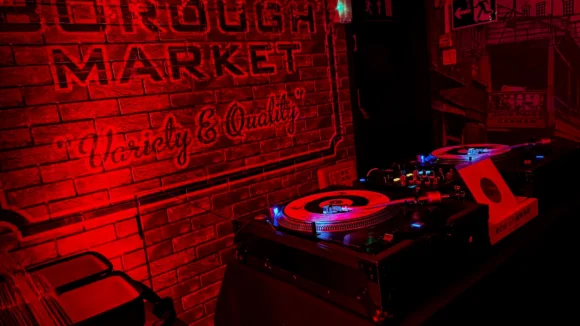 Vinyl DJ decks under red lighting in the 121 BASSment basement bar at St Christopher's Pub, Borough High Street, London Bridge