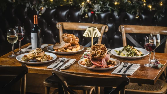 Festive dining setup at St Christopher's Pub with wine and traditional dishes.