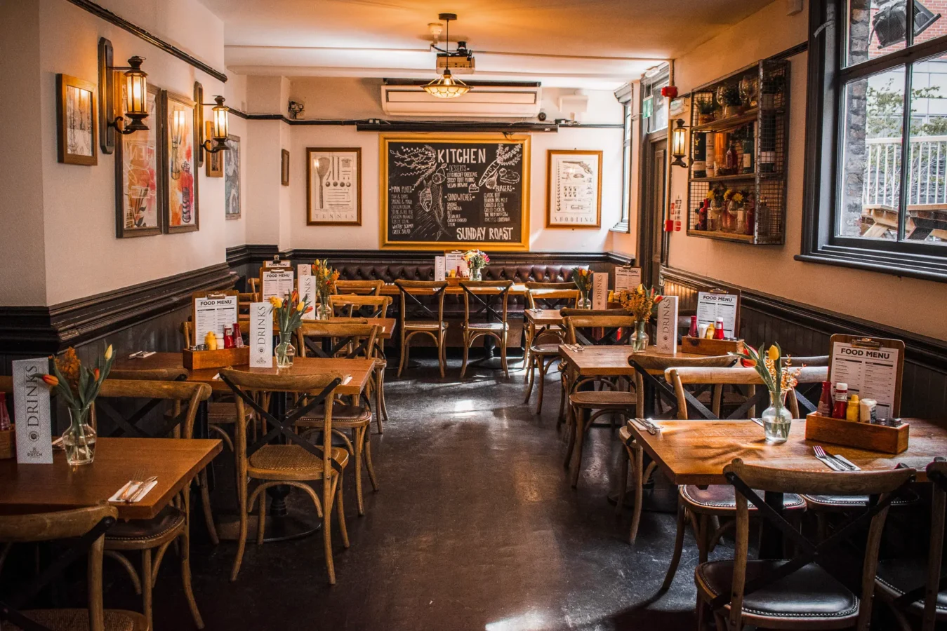 The dining room interior of St Christopher's Pub on Borough High Street, London Bridge, with wooden tables and chalkboard menu