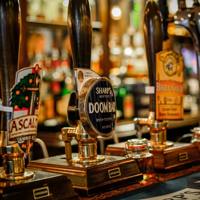 Real ale pump handles including Sharp's Doom Bar on the bar at St Christopher's Pub, Borough High Street, London Bridge