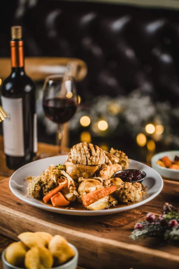 Appetising food plate with seafood, vegetables, and wine at St Christopher's Pub.