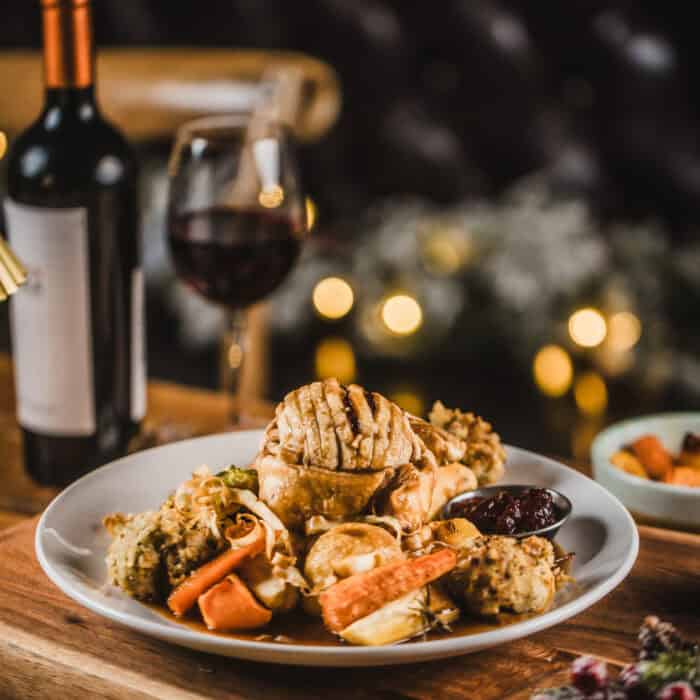 Appetising food plate with seafood, vegetables, and wine at St Christopher's Pub.