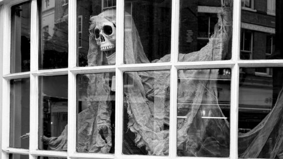 Decorative Halloween skeleton behind a window at The Inn.