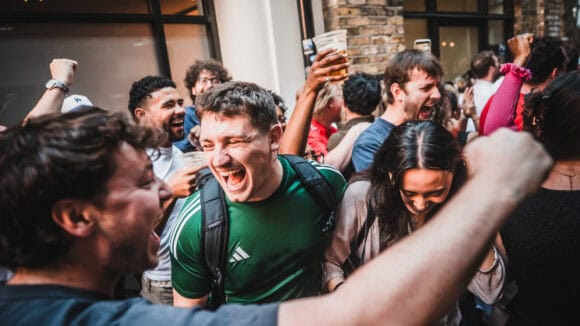 Happy group enjoying drinks and socialising at St Christopher's Pub.
