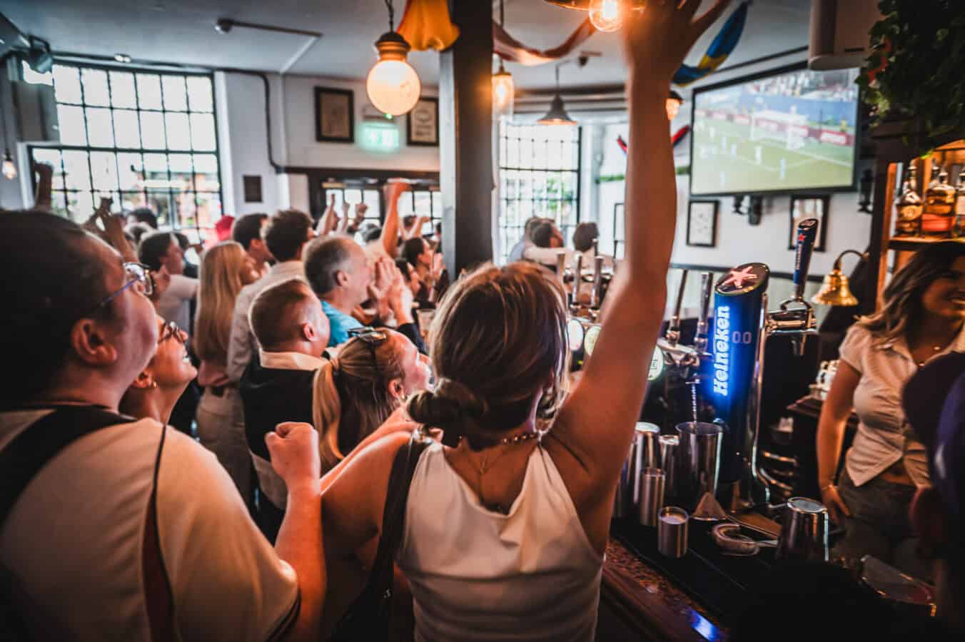Crowd watching live sports at St Christopher's Pub in London.
