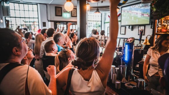 Crowd watching live sports at St Christopher's Pub in London.