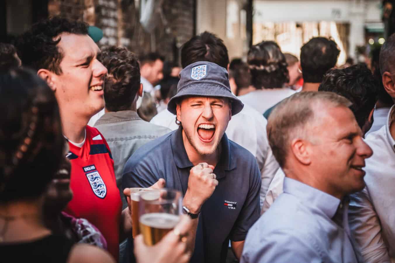 Crowd of people celebrating at St Christopher's Pub in London.
