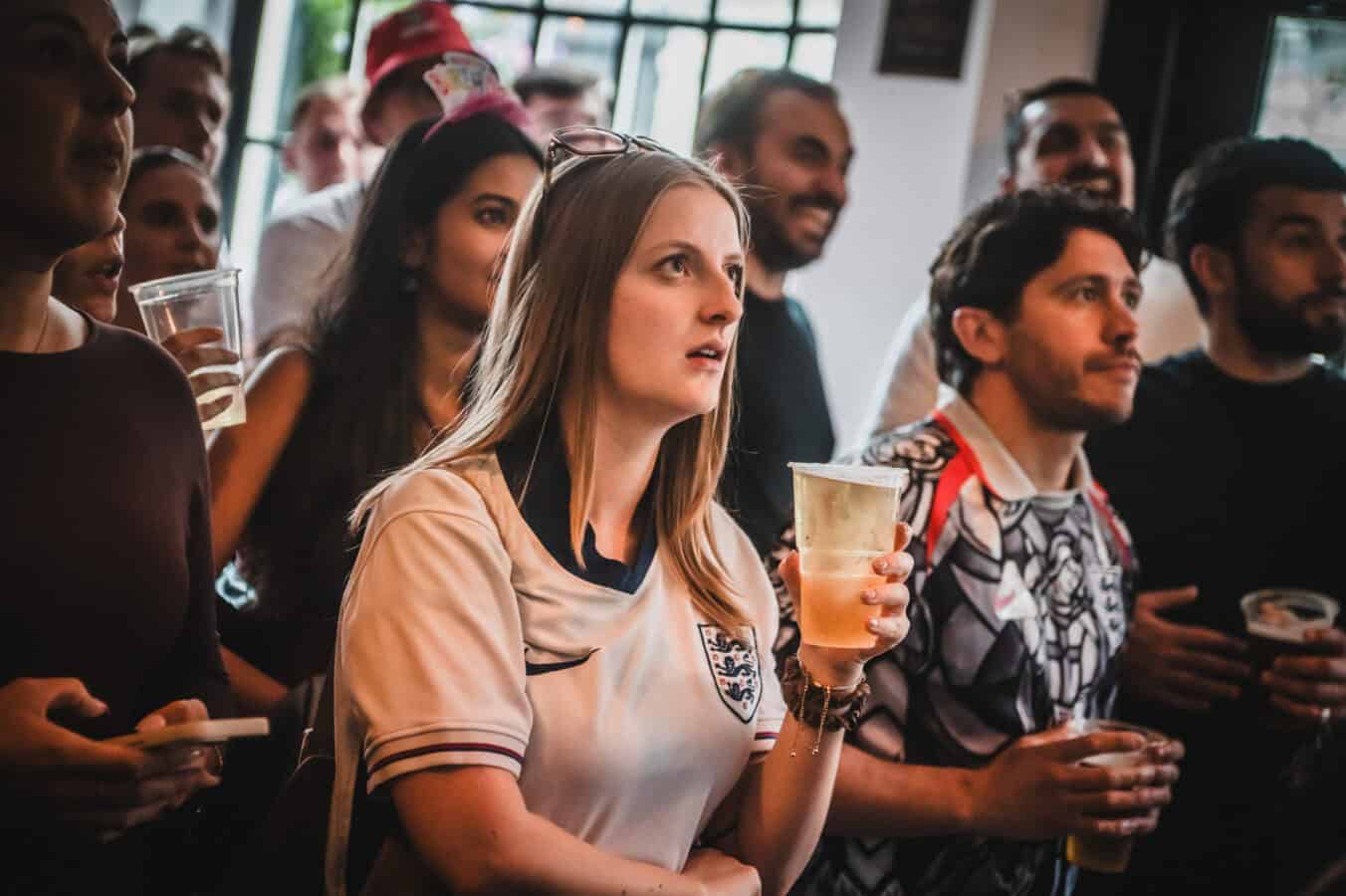 Group of people at St Christopher's Pub enjoying drinks and socialising.