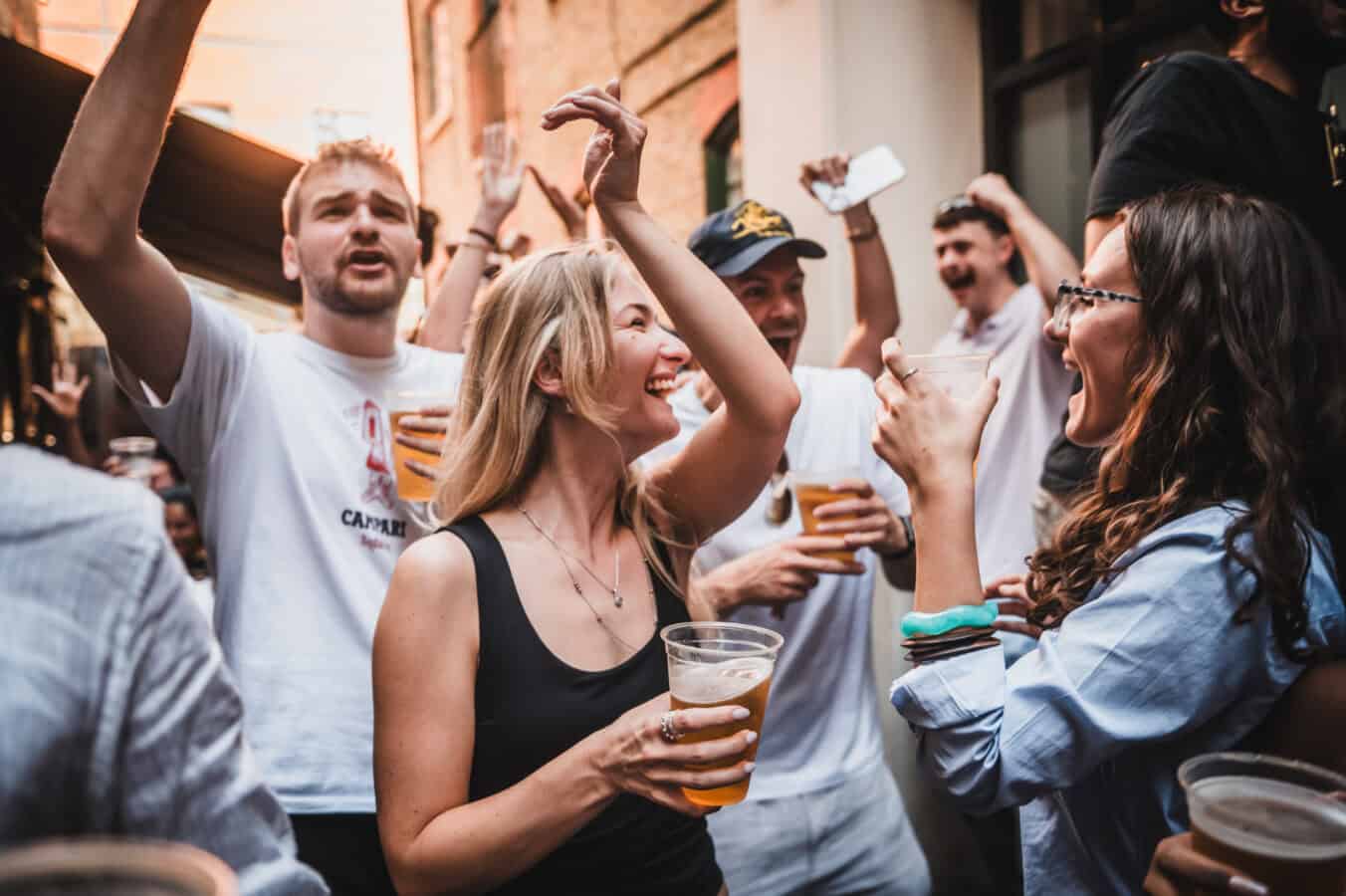 People enjoying drinks and music at St Christopher's Pub in a lively outdoor setting.