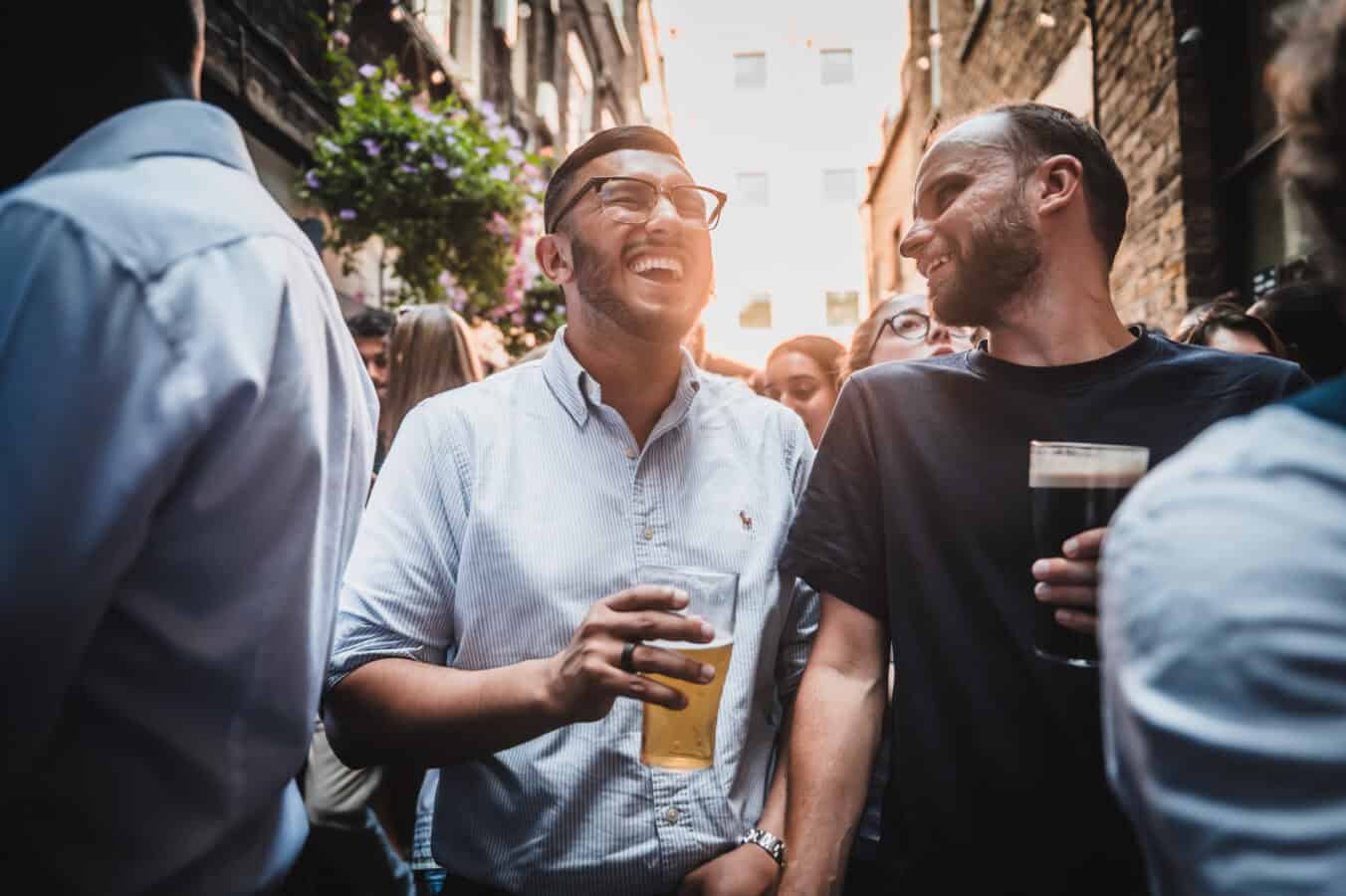 People enjoying drinks and conversation outside St Christopher's Pub.