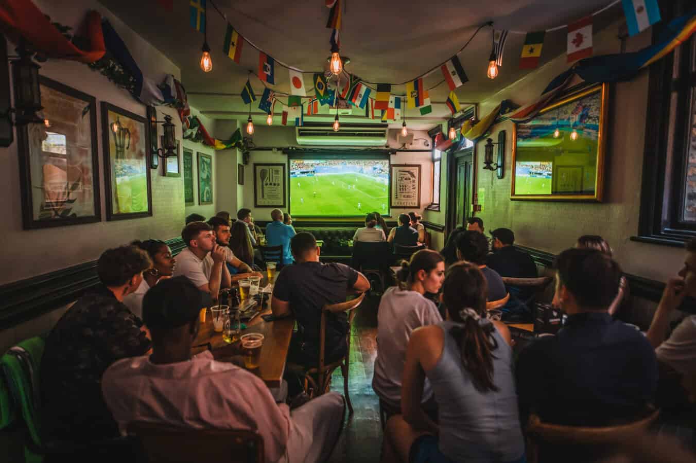 People watching football match at St Christopher's Pub in London.