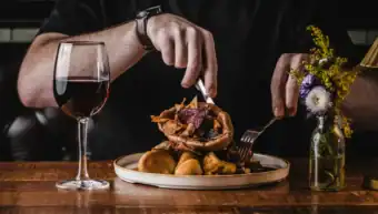 Gourmet meal served at St Christopher's Pub with wine and flowers.